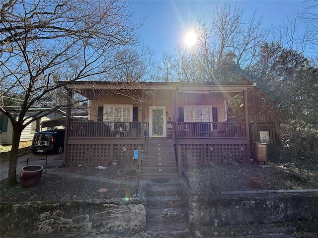 view of front facade with a carport, stairway, and a porch