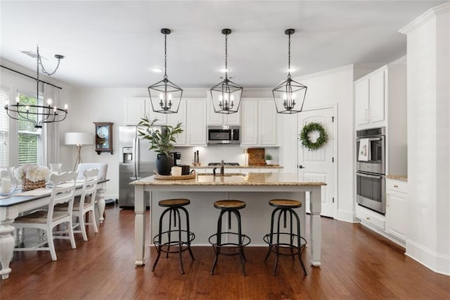 2680 Augeron Ct, Alpharetta, GA 30004 - kitchen featuring a chandelier, stainless steel appliances, dark wood-style flooring, a center island with sink, and ornamental molding