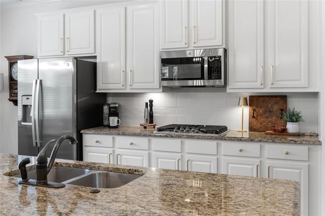 2680 Augeron Ct, Alpharetta, GA 30004 - kitchen with appliances with stainless steel finishes, a sink, white cabinetry, and decorative backsplash