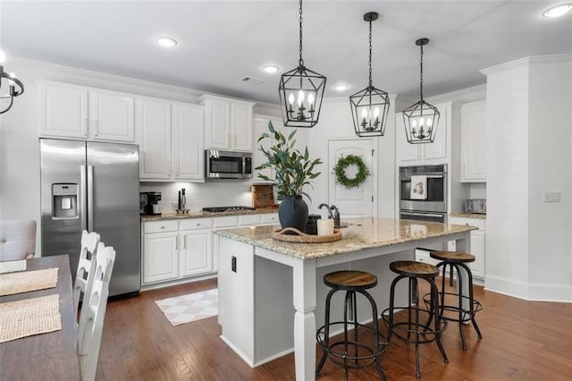 2680 Augeron Ct, Alpharetta, GA 30004 - kitchen with stainless steel appliances, a chandelier, dark wood-style floors, decorative light fixtures, and decorative backsplash