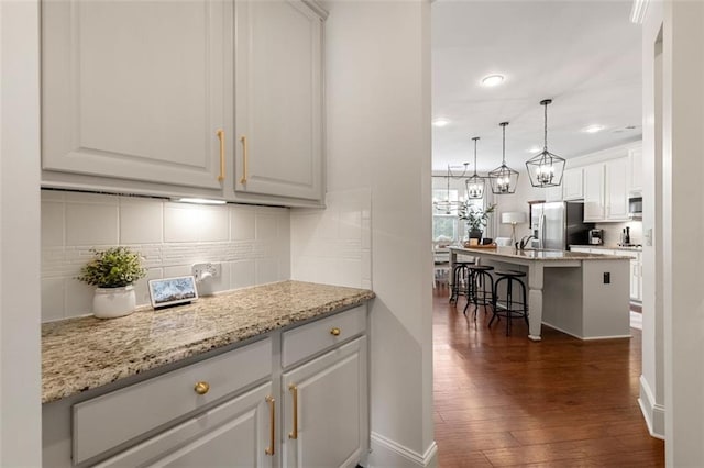 2680 Augeron Ct, Alpharetta, GA 30004 - kitchen with stainless steel fridge with ice dispenser, dark wood-style floors, white cabinets, tasteful backsplash, and recessed lighting