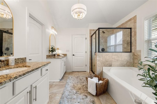 2680 Augeron Ct, Alpharetta, GA 30004 - full bathroom featuring a chandelier, two vanities, a stall shower, a garden tub, and lofted ceiling