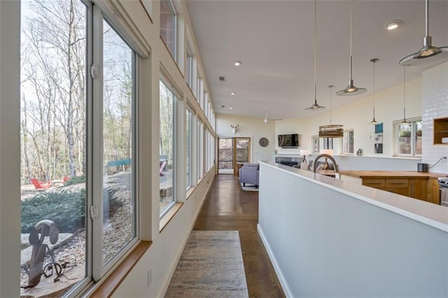 hallway featuring baseboards, dark wood-style flooring, and recessed lighting