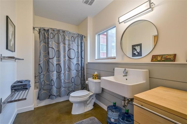 bathroom featuring toilet, a sink, visible vents, baseboards, and shower / bathtub combination with curtain
