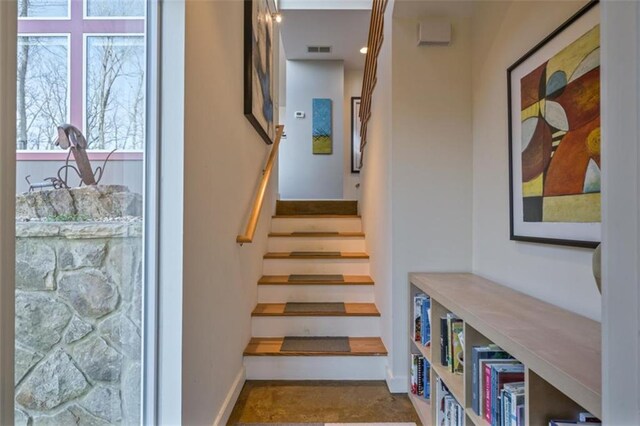 stairway with visible vents and baseboards