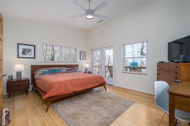 bedroom with visible vents, light wood finished floors, ceiling fan, baseboards, and access to exterior