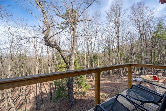 wooden deck featuring a wooded view