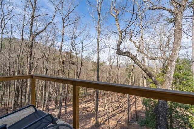 wooden deck with a forest view
