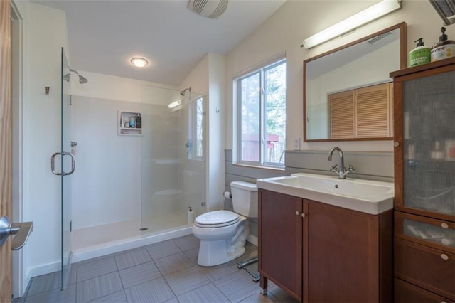 full bathroom featuring toilet, tile patterned flooring, vanity, and a stall shower