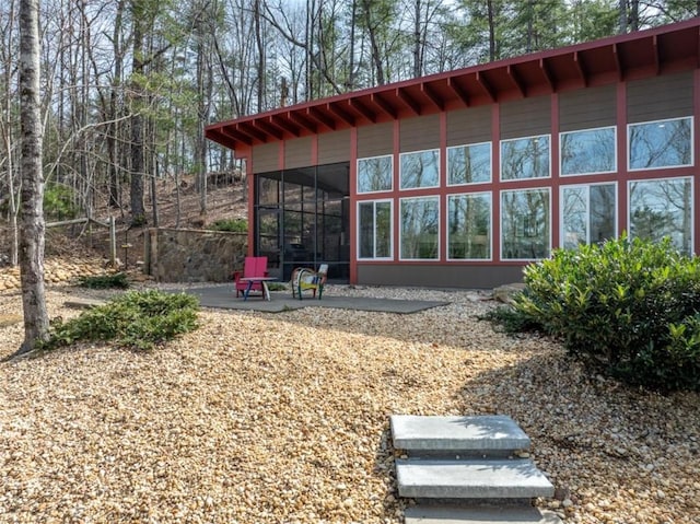 exterior space with a patio area and a sunroom