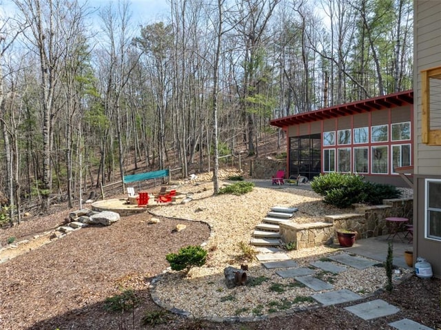 view of yard with a sunroom and a patio area