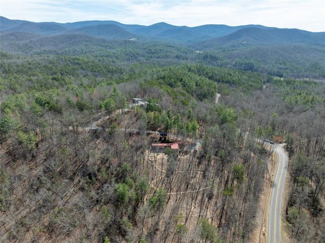 drone / aerial view featuring a mountain view and a view of trees