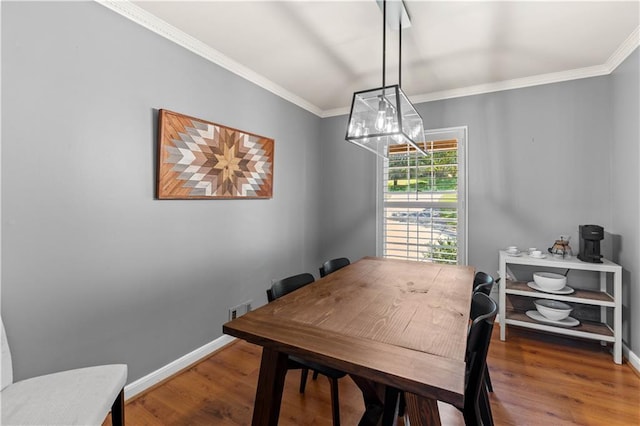 650 Crestview Ter, Gainesville, GA 30501 - dining area with crown molding, wood finished floors, and a chandelier
