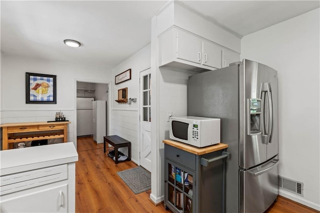 650 Crestview Ter, Gainesville, GA 30501 - kitchen with white appliances, light wood-type flooring, white cabinetry, and light countertops