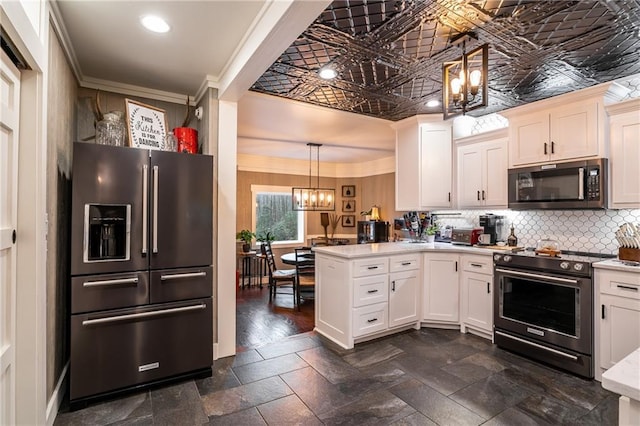 kitchen featuring an ornate ceiling, ornamental molding, a peninsula, stainless steel appliances, and light countertops