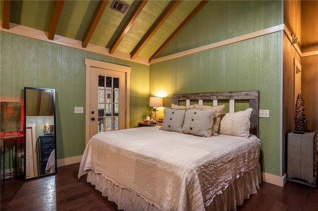 bedroom featuring visible vents, vaulted ceiling with beams, wood walls, and wood finished floors