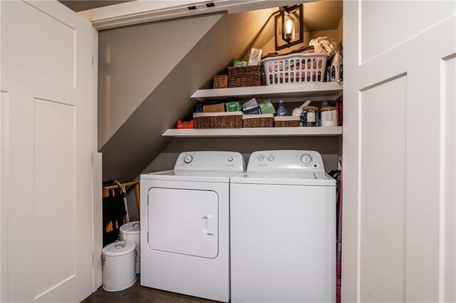 laundry area with laundry area, wood finished floors, and washing machine and clothes dryer