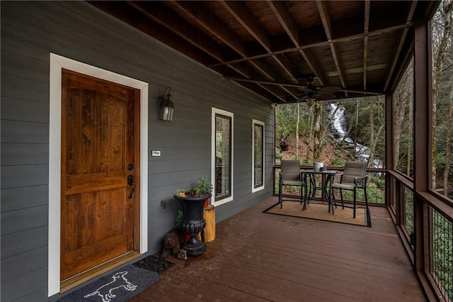 wooden terrace with a porch and ceiling fan