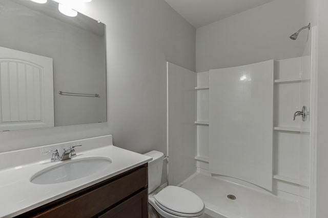 full bath featuring a shower, vanity, and toilet