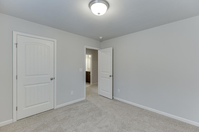 unfurnished bedroom with carpet floors and baseboards