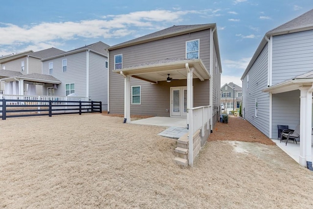 rear view of house with ceiling fan, a patio, a fenced backyard, french doors, and a residential view