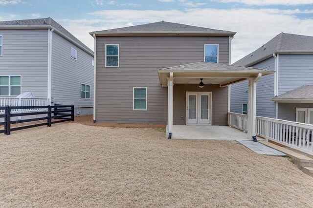 rear view of house with french doors, a fenced backyard, a patio, and roof with shingles