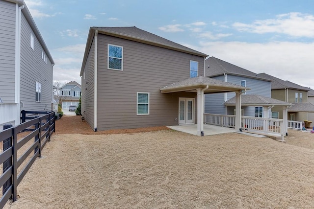 rear view of house featuring french doors, a patio area, and fence