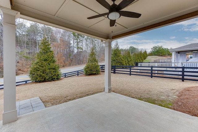 view of patio featuring fence and a ceiling fan