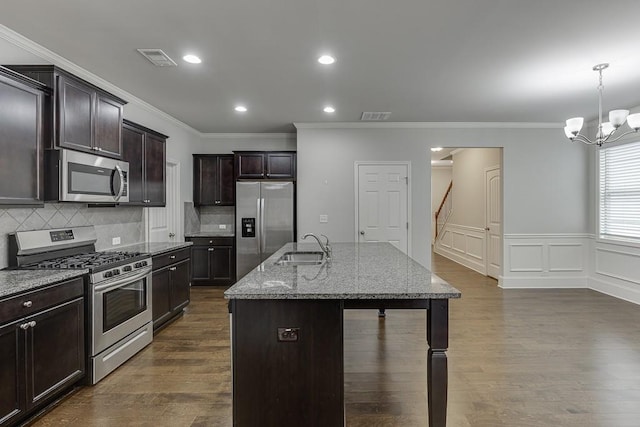 kitchen with stone counters, visible vents, appliances with stainless steel finishes, and a sink