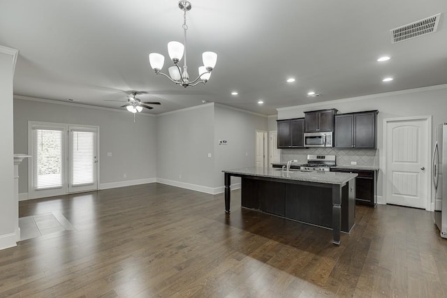 kitchen featuring a breakfast bar, dark wood finished floors, visible vents, backsplash, and appliances with stainless steel finishes