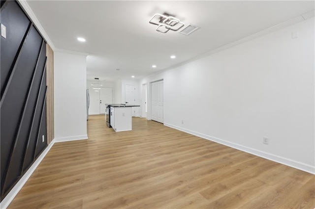 unfurnished living room with light hardwood / wood-style flooring and ornamental molding