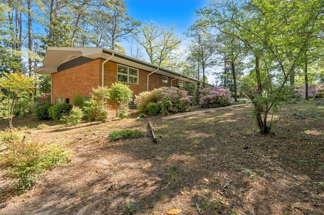 view of side of home with brick siding
