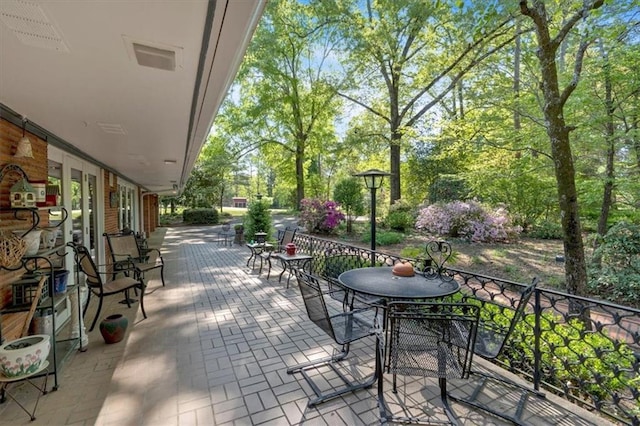 view of patio featuring view of wooded area