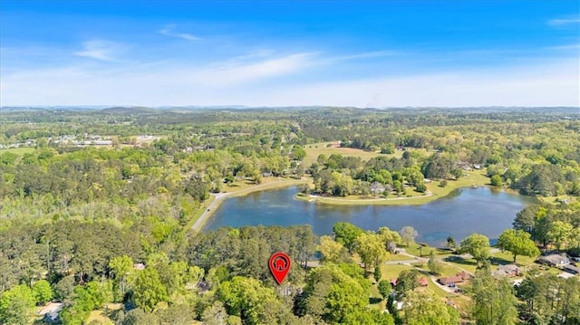 aerial view of property and surrounding area with a forest and a large body of water