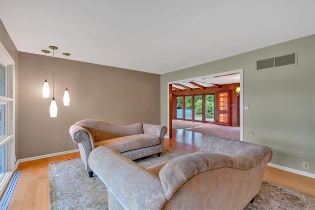 living area featuring light wood-type flooring and baseboards