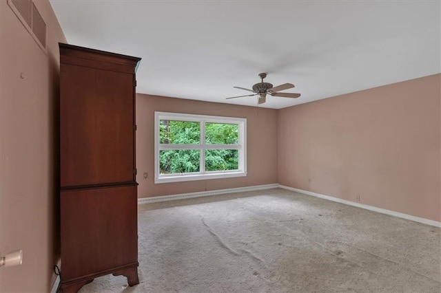 empty room featuring a ceiling fan, baseboards, and carpet floors