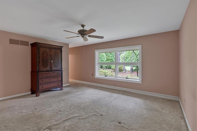 unfurnished bedroom with baseboards, carpet, and a ceiling fan