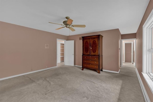 unfurnished bedroom featuring light colored carpet, baseboards, and ceiling fan