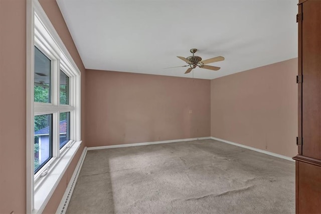 spare room featuring carpet, ceiling fan, and baseboards