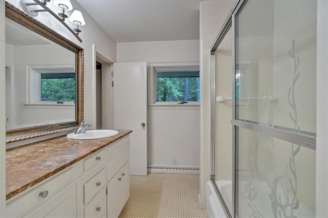 full bath featuring healthy amount of natural light, a baseboard radiator, vanity, and bath / shower combo with glass door