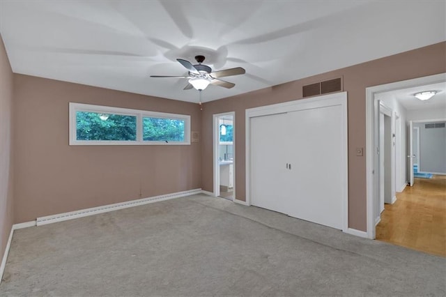 unfurnished bedroom with carpet floors, baseboards, a closet, and ceiling fan
