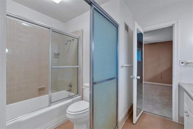 full bath with toilet, enclosed tub / shower combo, vanity, baseboards, and tile patterned flooring