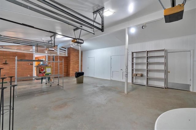 garage with a garage door opener and wooden walls