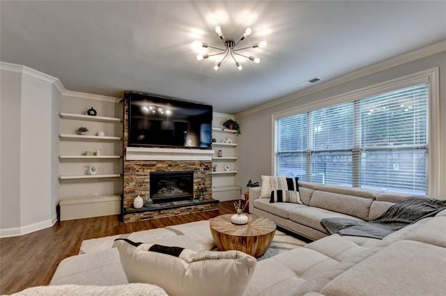 4335 Bellview Ln, Duluth, GA 30097 - living area with a chandelier, wood finished floors, crown molding, a stone fireplace, and built in shelves