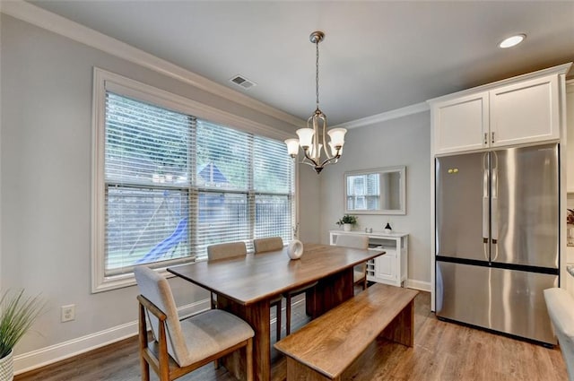 4335 Bellview Ln, Duluth, GA 30097 - dining area with a chandelier, ornamental molding, and light wood-type flooring