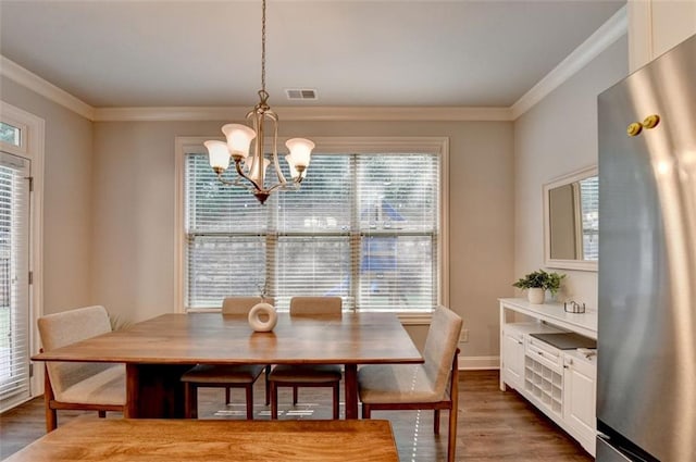 4335 Bellview Ln, Duluth, GA 30097 - dining area featuring a chandelier, ornamental molding, and wood finished floors