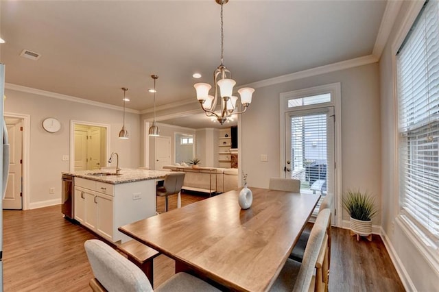 4335 Bellview Ln, Duluth, GA 30097 - dining room featuring wood finished floors, a chandelier, ornamental molding, and recessed lighting