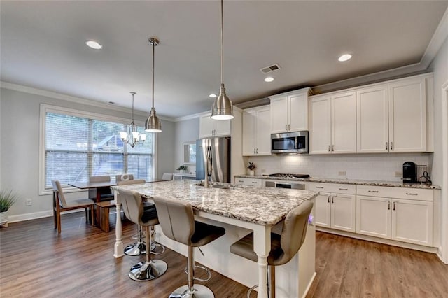 4335 Bellview Ln, Duluth, GA 30097 - kitchen with appliances with stainless steel finishes, crown molding, backsplash, light stone counters, and white cabinetry