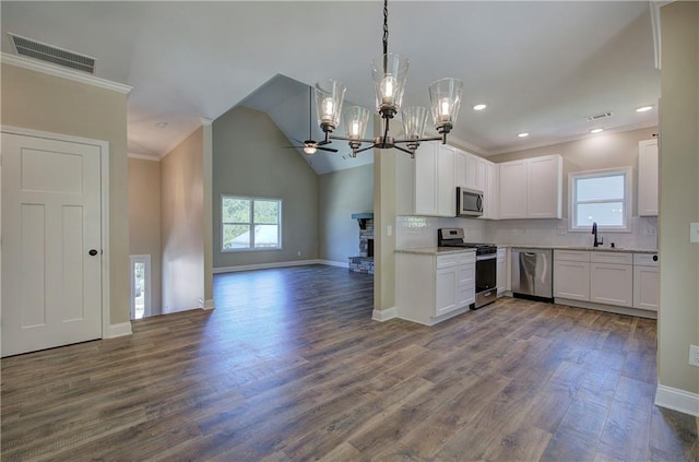 311 Arbor Cir, Rockmart, GA 30153 - kitchen featuring appliances with stainless steel finishes, plenty of natural light, open floor plan, white cabinetry, and ornamental molding