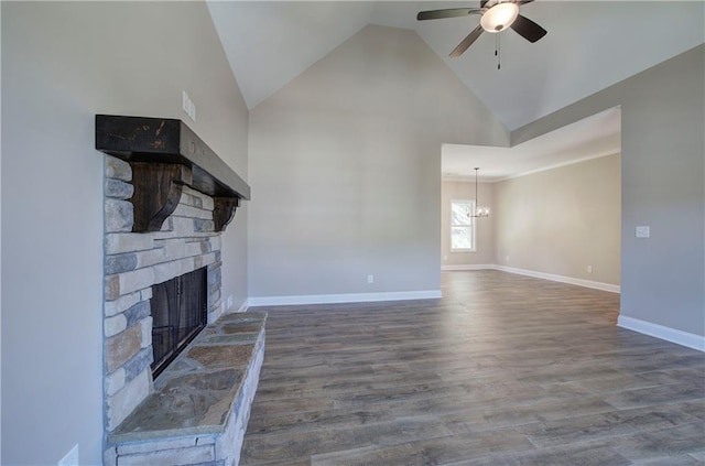 311 Arbor Cir, Rockmart, GA 30153 - unfurnished living room with a stone fireplace, a ceiling fan, a chandelier, wood finished floors, and high vaulted ceiling